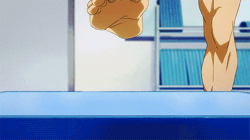 a person standing on a blue surface with a fist in the air
