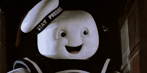 a close up of a marshmallow man wearing a sailor hat and a band that says stay pressed
