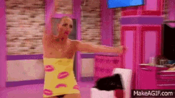 a man is wrapped in a yellow towel with pink lips on it .