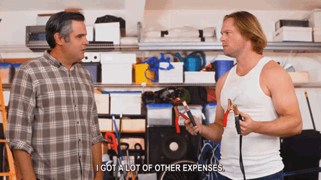 two men are standing in a garage and one of them is saying i got a lot of other expenses
