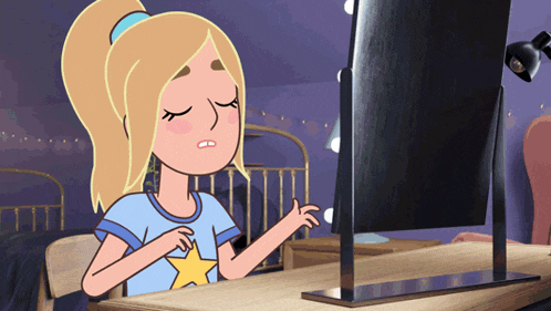 a girl in a blue shirt with a yellow star on it is looking at herself in a mirror