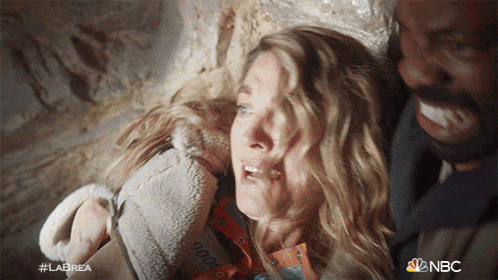 a woman is crying while a man holds her in his arms with the nbc logo in the corner