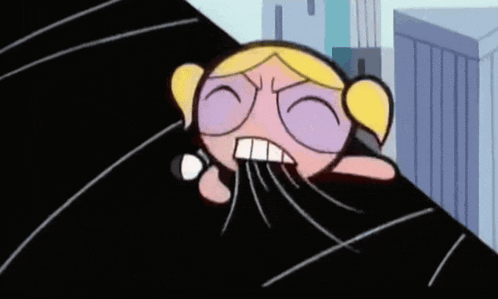 a cartoon character from the powerpuff girls is laying on a black surface .