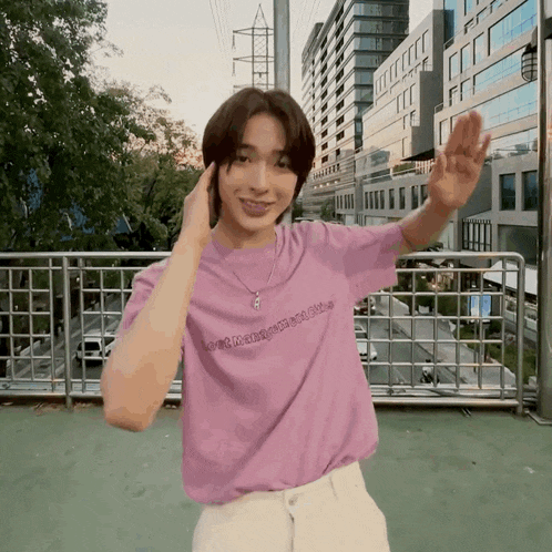 a young man wearing a purple shirt that says ' love mangoes ' on it