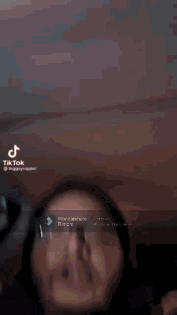 a woman wearing glasses is making a funny face in a tik tok video
