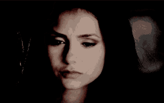 a close up of a woman 's face with dark hair