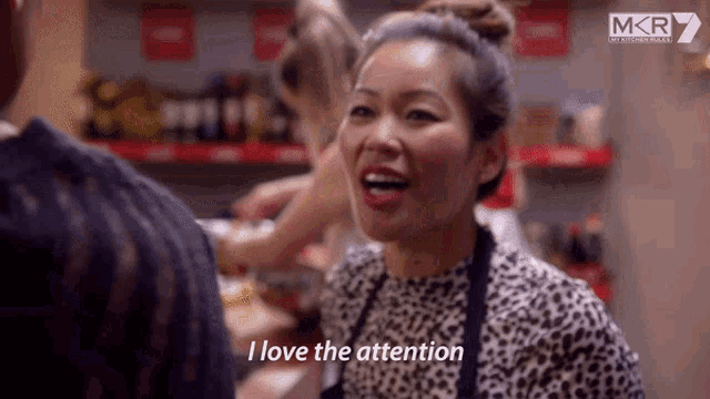 a woman says " i love the attention " while wearing an apron