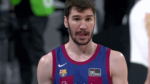 a man with a beard is wearing a barcelona jersey