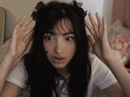 a girl with a star on her face is making a face