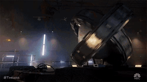a large object is sitting on the floor in a dark room with a light coming out of it .