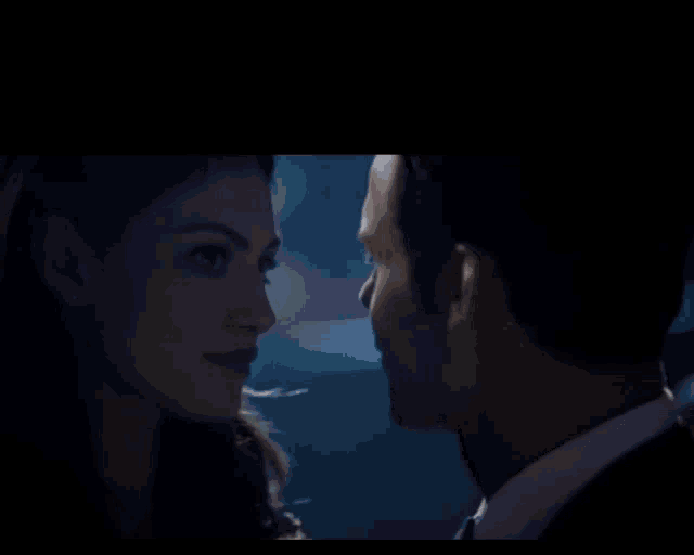 a man in a suit and tie dancing with a woman in a blue dress