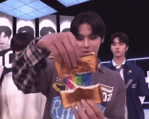 a man is holding a piece of toast that says ritz on it