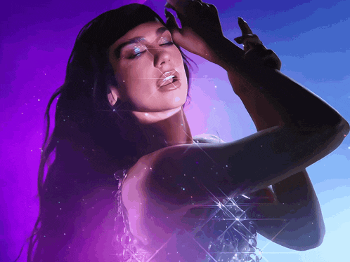 a woman in a purple and blue background with sparkles on her face