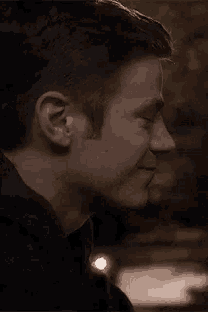 a close up of a man 's face with a smile on it .