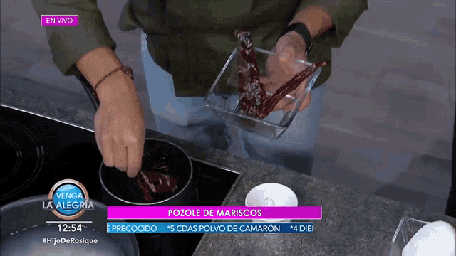 a person preparing food on a television show called la alegria