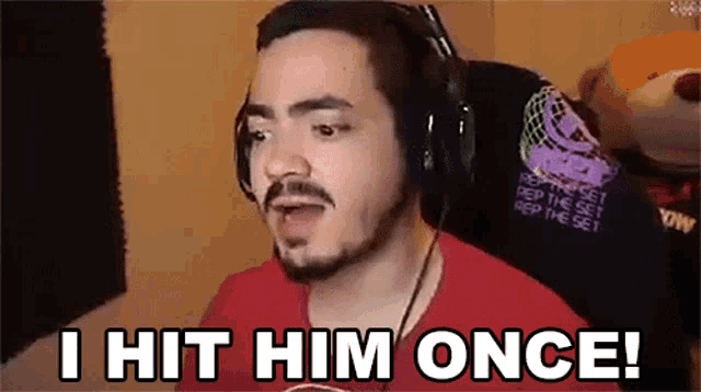 a man with a beard wearing headphones says i hit him once