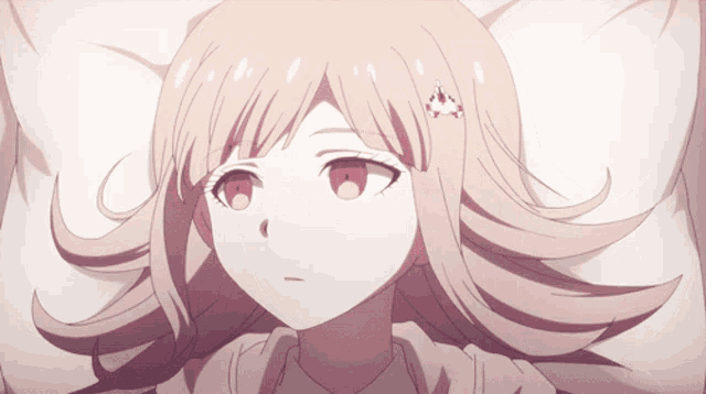 a girl with pink hair and red eyes is laying on a bed