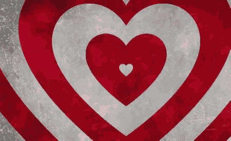 a red and white heart with a smaller heart in the middle of it .