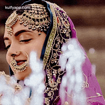 a close up of a woman wearing a veil and a nose ring