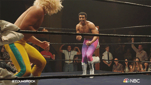 two wrestlers in a ring with nbc on the bottom right