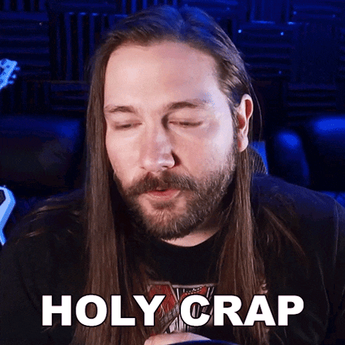 a man with long hair and a beard has the words holy crap above his head