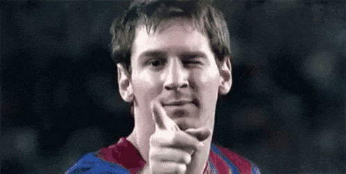 a close up of a soccer player giving a thumbs up sign