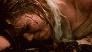 a close up of a person laying on the ground with blood coming out of their head .