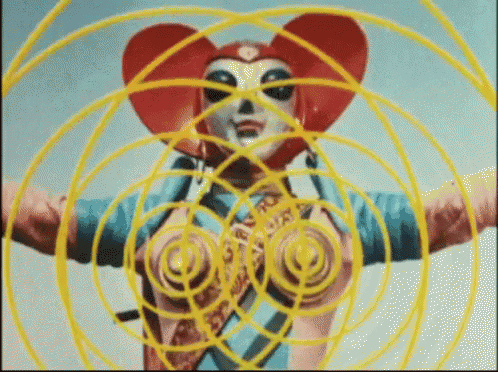 a cartoon character with a heart shaped hat is surrounded by yellow circles