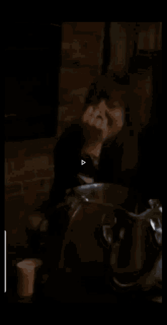 a woman sitting at a table with a purse
