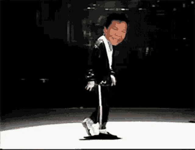 a man in a black jacket and white pants is dancing on a white surface