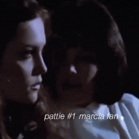 a close up of two women kissing with the words " pattie # 1 marcia fan " below them