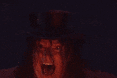 a woman in a top hat is screaming with her mouth wide open