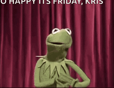 kermit the frog is standing on a stage with a red curtain in the background .