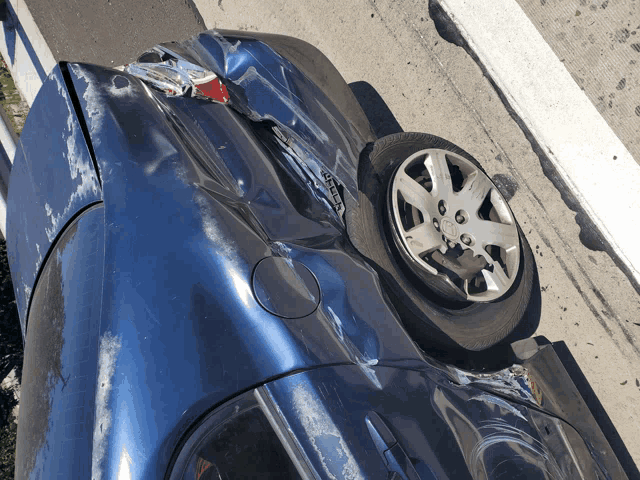 a damaged car with a license plate that says ' a ' on it