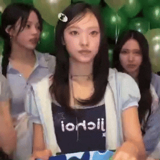 a girl wearing a shirt that says ioaoii
