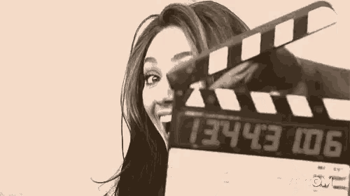 a black and white photo of a woman laughing .