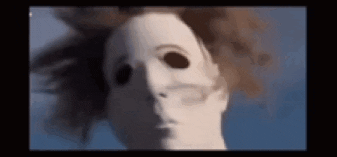 a close up of a doll 's face with a white mask on .