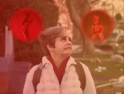 a woman with a backpack is standing in front of a red circle with a picture of a devil in it .