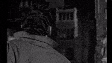 a black and white photo of a man 's face looking up