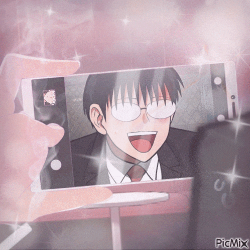 a person is taking a picture of a man with glasses on their phone with picmix on the bottom