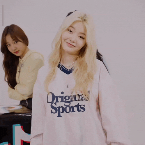 a girl wearing a shirt that says original sports on it