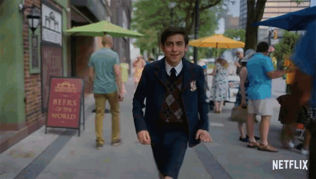 a man in a suit is running down a street with a sign that says " beers of the world "