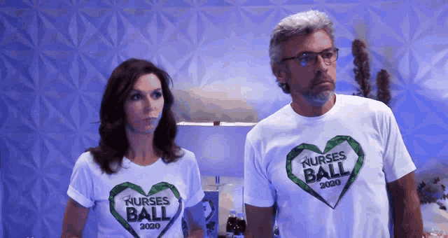 a man and a woman wearing nurses ball 2020 shirts stand next to each other