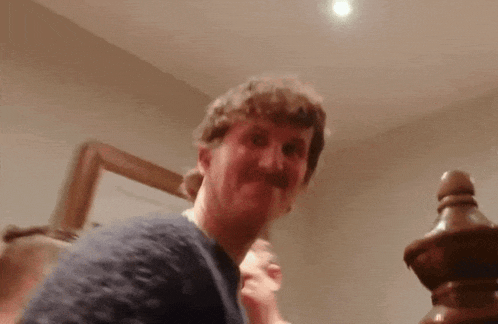 a man with a mustache is making a funny face in a blurry photo