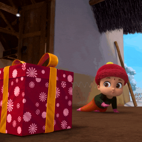 a little girl is crawling next to a large red gift box with pink flowers on it