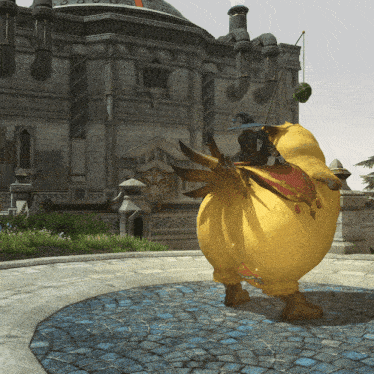 a yellow chicken with a red saddle is standing in front of a large building