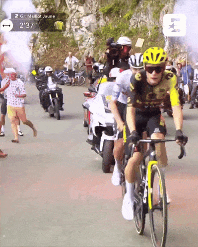 a man riding a bike with the time of 2:37 on the screen behind him