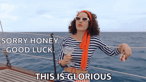 a woman sitting on a boat holding a martini says " sorry honey good luck this is glorious "
