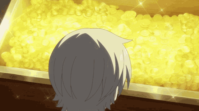 a person looking at a pile of gold coins in a box