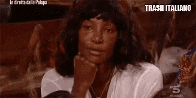 a woman sitting in a chair with her hand on her chin and the words trash italiano on the bottom